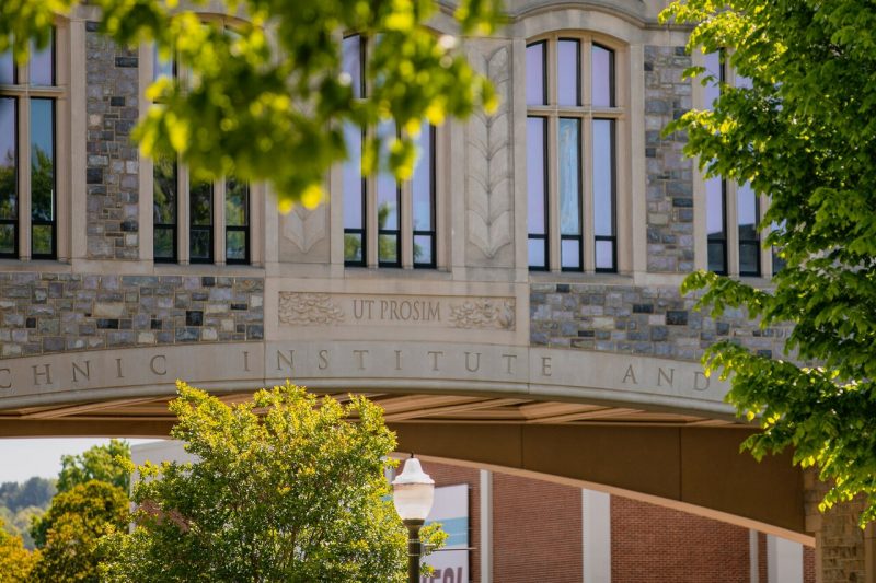 The words "Ut Prosim," which means That I May Serve, is carved into the stone of a Virginia Tech building.