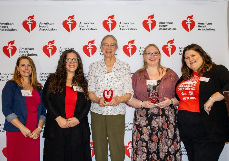 Awardees Carrie Kroehler and Ashley Sloan stand with Roanoke Women in STEM award organizers.