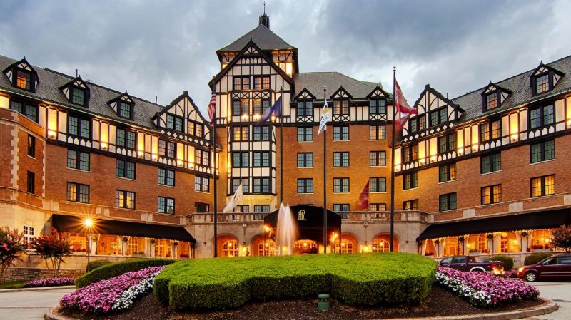 A tudor-style hotel under a stormy sky.
